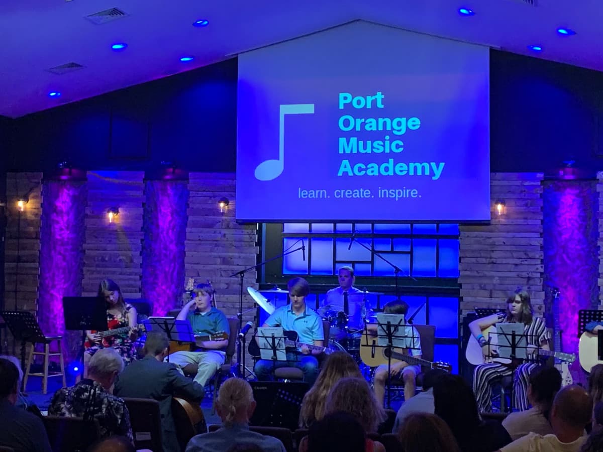 POMA students performing together on stage